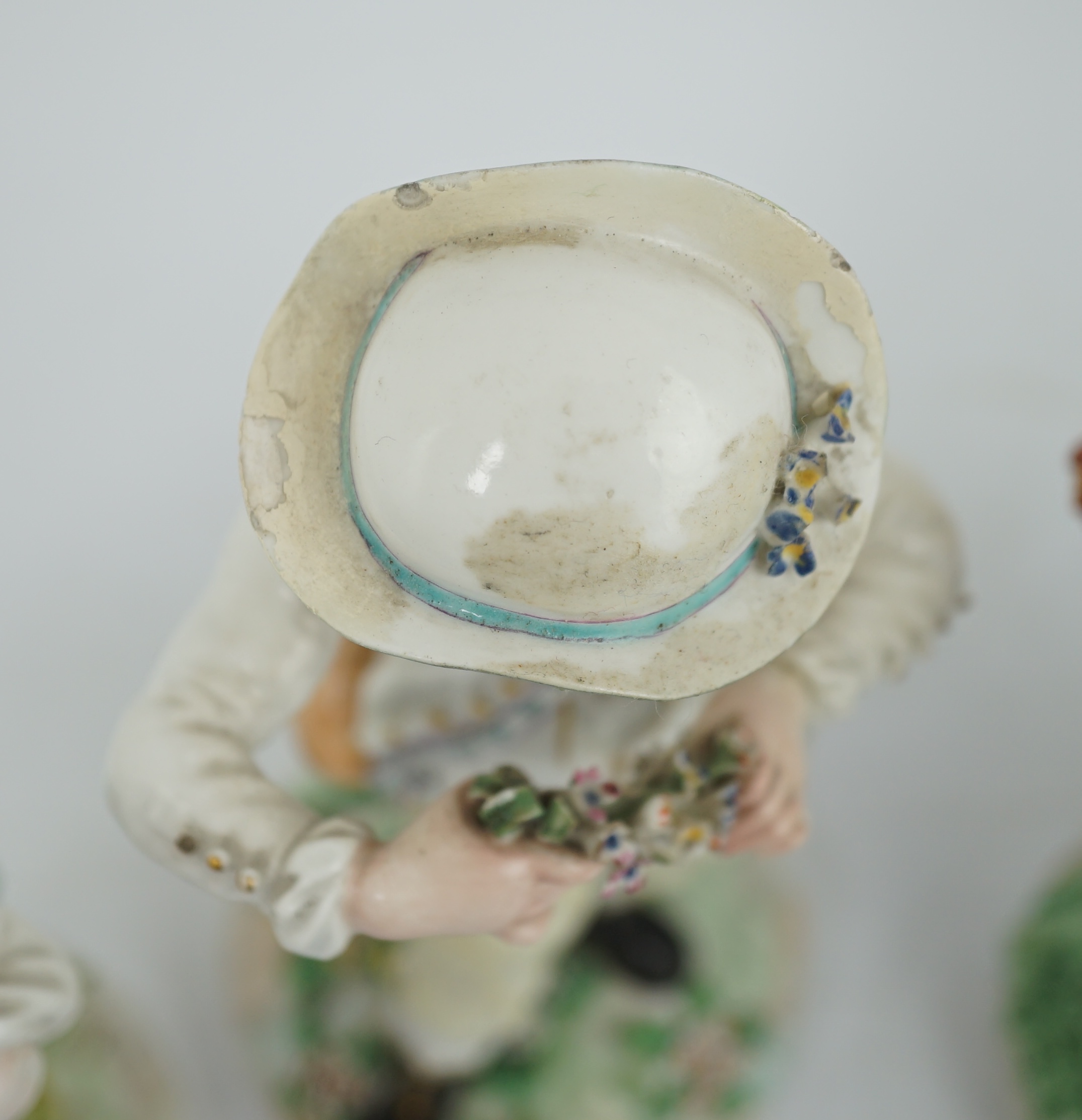 A composed set of four Derby figures emblematic of the Seasons, late 18th century, modelled by Pierre Stephan, the figures of Spring, Summer and Winter on circular bases, the figure of Autumn on a scrollwork base, 21cm t